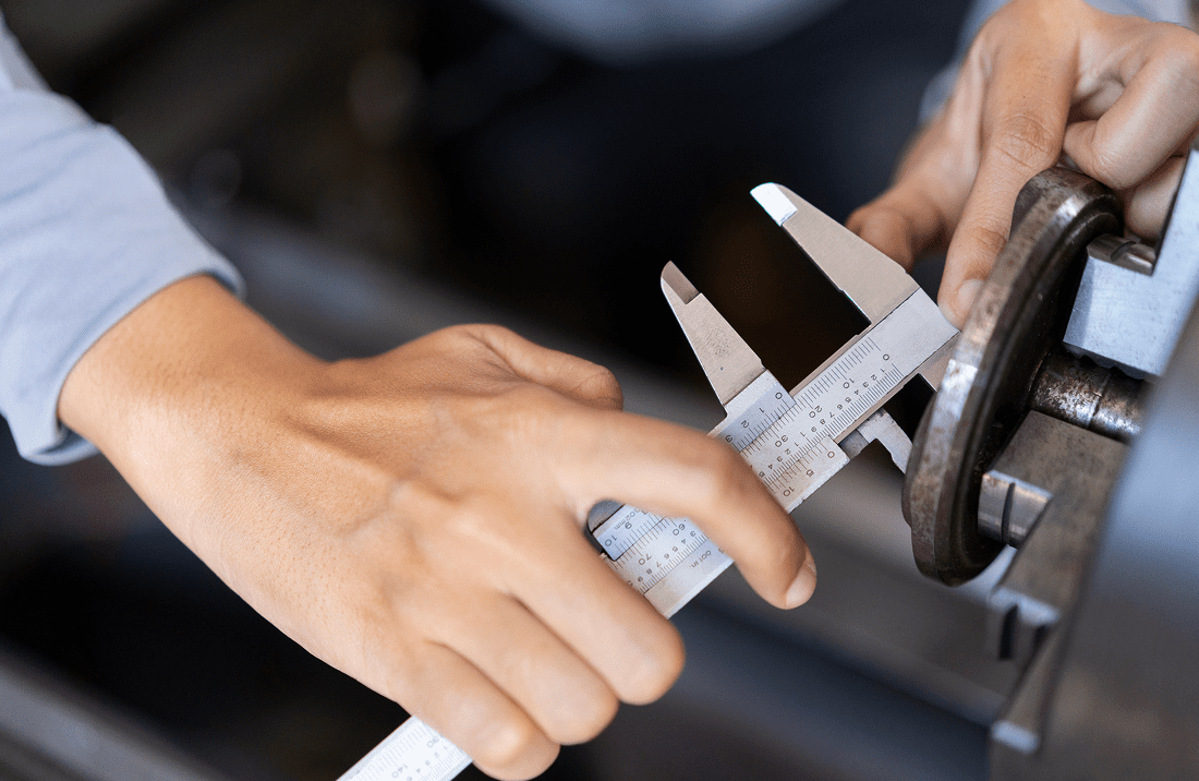 Hands using caliper for precise measurement