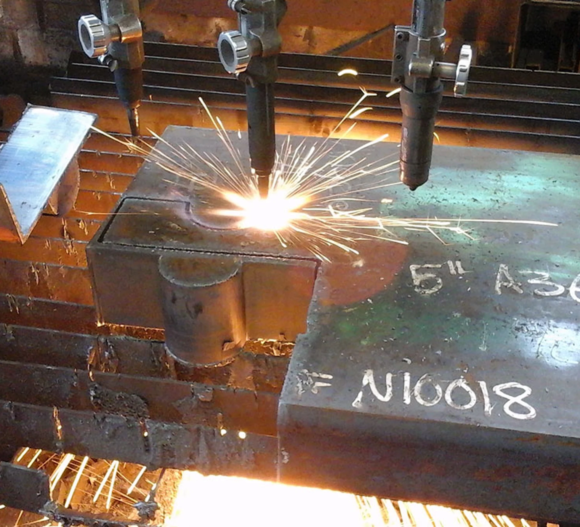 CNC machine cutting thick metal sheet