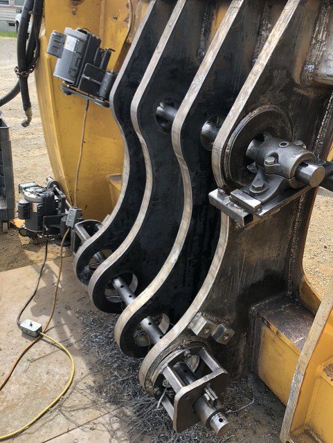 Close-up of mechanical parts with belts and pulleys in a workshop.